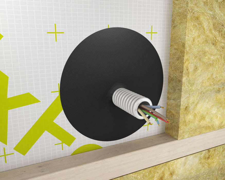 Round DAFA TriFlex airtight cable grommet sealing a corrugated flex conduit with multi-core cable through a membrane; insulation and timber batten visible.